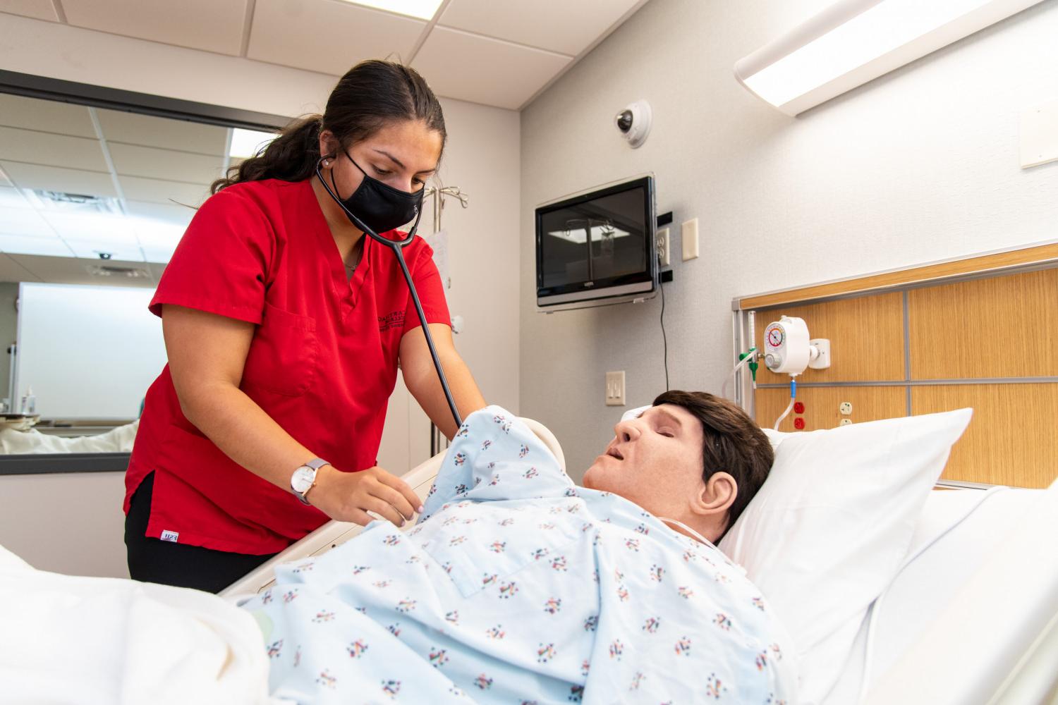 A nursing major practices skills in the Carthage nursing lab.